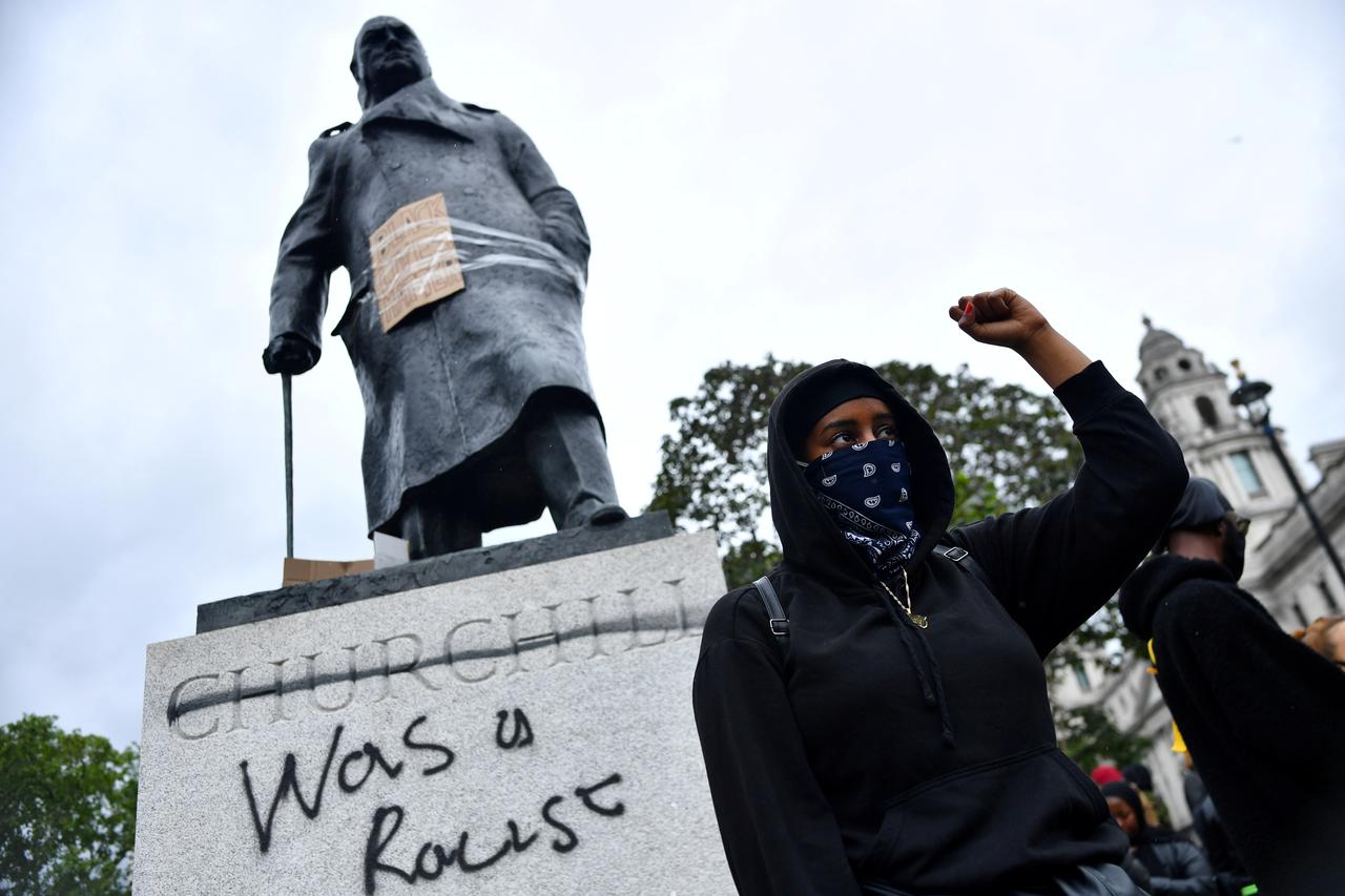 A demonstrator reacts infront of graffiti on a statue of Winston Churchill in Parliament Square during a Black Lives Matter protest in London, following the death of George Floyd who died in police custody in Minneapolis, London, Britain, June 7, 2020. Photo: Reuters/Dylan Martinez/File Photo